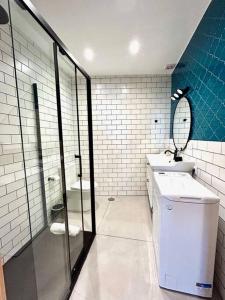 een badkamer met een toilet, een wastafel en een spiegel bij Hispalis Columnas de la Alameda in Sevilla