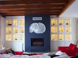 a living room with a couch and a blue wall at Beautiful French mountain home in Marignier