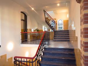 a staircase in a building with a red railing at DoubleTree by Hilton Sittard in Sittard