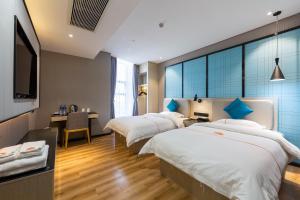 Postelja oz. postelje v sobi nastanitve Warm Yes Business Hotel -Free shuttle bus during the Canton Fair