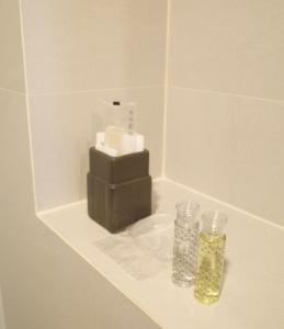 a bathroom counter with two bottles of liquids on it at Now Hostel in Ban Chang
