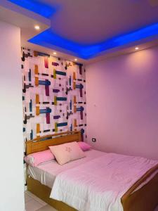 a bedroom with a bed with a colorful wall at سيسيليا ريزورت in Hurghada