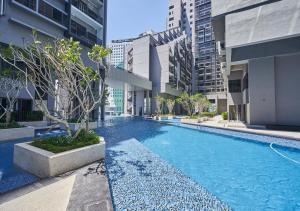 a swimming pool in a city with tall buildings at Imperio Residence Melaka by Jeffery Lam Home Management in Melaka