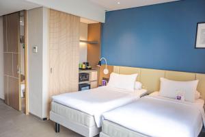 Voodi või voodid majutusasutuse ibis Styles Bogor Pajajaran toas