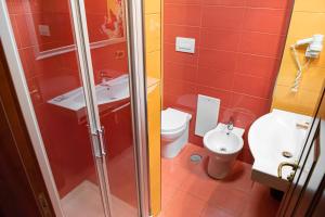 a bathroom with a shower and a sink and a toilet at Hotel Bellavista in Marina di Varcaturo