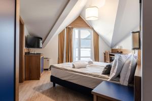 Postel nebo postele na pokoji v ubytování Hotel garni Meledrio