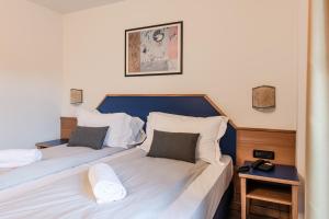Postel nebo postele na pokoji v ubytování Hotel garni Meledrio