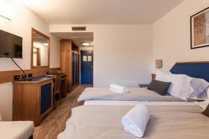 Postel nebo postele na pokoji v ubytování Hotel garni Meledrio