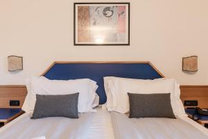 Postel nebo postele na pokoji v ubytování Hotel garni Meledrio