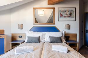Postel nebo postele na pokoji v ubytování Hotel garni Meledrio