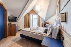 Postel nebo postele na pokoji v ubytování Hotel garni Meledrio