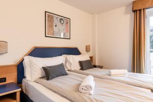 Postel nebo postele na pokoji v ubytování Hotel garni Meledrio