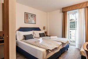Postel nebo postele na pokoji v ubytování Hotel garni Meledrio