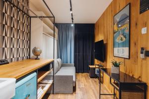 a living room with a couch and a tv at City Glamping by ONE66 Hotel in Ljubljana