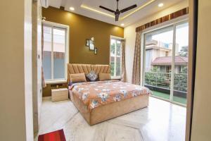 a bedroom with a large bed and large windows at IN 4BHK VILLA LONAVALA in Lonavala +64 photos
