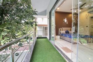 a house with a balcony with green grass at IN 4BHK VILLA LONAVALA in Lonavala