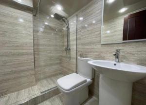 a bathroom with a toilet and a sink and a shower at Days Hotel in Yerevan +22 photos
