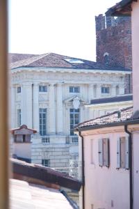 a large white building with a clock on it at PALAZZO CIOPETA - Italian Excellence in Verona +40 photos