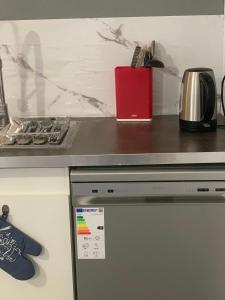 a kitchen with a counter top with a stove at Maison entière proche circuit des 24 heures in Le Mans