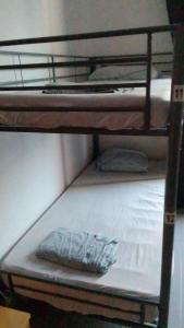 a bunk bed with a pillow on the bottom bunk at Famara Home stay in Famara