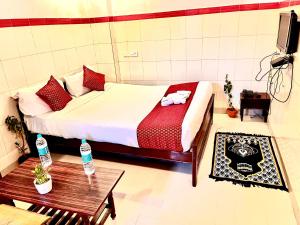 a bedroom with a bed and a table and a tv at HOTEL SITA GRAND in Shamshabad