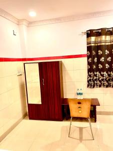 a room with a red door and a wooden chair at HOTEL SITA GRAND in Shamshabad