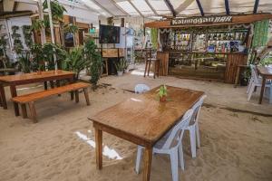a room with tables and chairs in a store at Victoria Beach House in San Vicente
