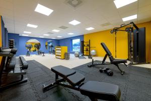 a gym with several treadmills and machines at ibis Styles Rotterdam Ahoy in Rotterdam