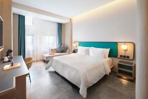 Postel nebo postele na pokoji v ubytování VIVERE Hotel, ARTOTEL Curated