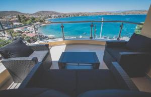 a balcony with chairs and a table and the ocean at Mardel_seaside_selinia in Salamina