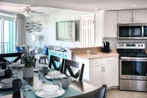 a kitchen and dining room with a table and chairs at 2501 S Ocean Blvd, 1031 - Ocean View Sleeps 8 in Myrtle Beach