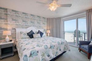 a bedroom with a bed with a view of the ocean at 2501 S Ocean Blvd, 1031 - Ocean View Sleeps 8 in Myrtle Beach