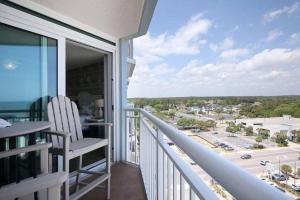 a balcony with a chair and a view of a city at 2501 S Ocean Blvd, 1031 - Ocean View Sleeps 8 in Myrtle Beach
