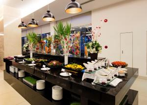 a buffet in a hotel with fruits and vegetables at TTC Hotel - Michelia in Nha Trang