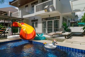 a house with a swimming pool with a inflatable slide at Villa w/ Pool-Nimman(near Maya) Chiangmai by Fahsai in Chiang Mai