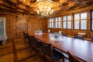 a large room with a large wooden table and chairs at Wysses Rössli Swiss Quality Hotel in Schwyz