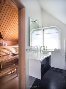 a bathroom with a sink and a window at Strandhaus La Vela in Olpenitz