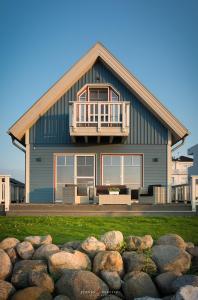 a large house with a balcony on top of it at Strandhaus La Vela in Olpenitz