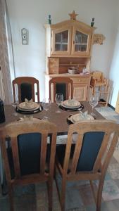 a table with wine glasses on top of it at Ferienwohnung Haus am Berg in Innernzell