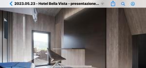 a website for a hotel lobby with a chair and a window at rest bellavista in Maloja