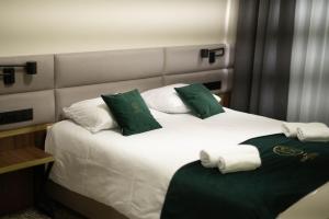 Postel nebo postele na pokoji v ubytování Restoria Hotel***