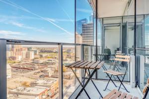 a balcony with a table and chairs on a building at Downtown 1br w gym wd near restaurants ATX-230 in Austin