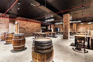 a room with tables and chairs and brick walls at Hotel Savannah in Chvalovice