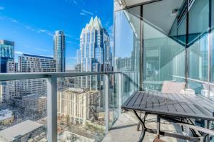 a balcony with a bench and a view of the city at Downtown 2br w lounge deck wd pool ATX-231 in Austin