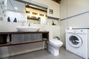 a bathroom with a sink and a washing machine at Apartment between Akropolis and Soboras in Kaunas