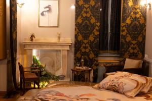 a bedroom with a bed and a fireplace at Medουσία Wellness Spa Heritage Suites in Chalkida +79 photos