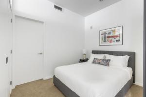 a bedroom with a white bed and white walls at Downtown studio w gym laundry nr shopping BOS-987 in Boston