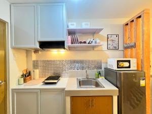 a kitchen with a sink and a refrigerator at Studio Unit-8 Spatial Condo in Davao City