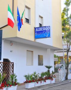 a hotel with two flags on the side of it at Hotel Sette Note in Silvi Marina
