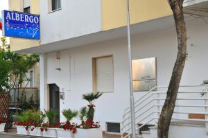 a building with a sign on the side of it at Hotel Sette Note in Silvi Marina
